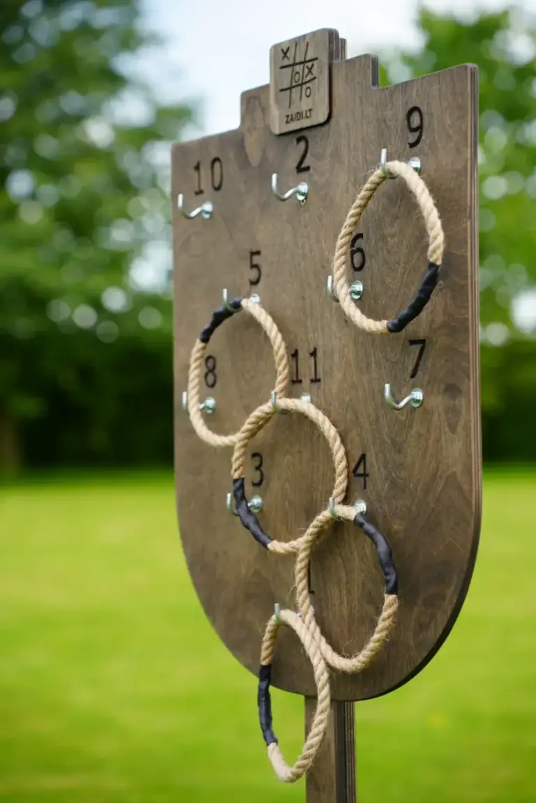 Medinis taiklumo žaidimas „Žiedų karalius“ – virviniai žiedai metami į vertikaliai stovinčią taikinio lentą.