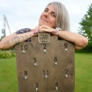 Dovilė, founder of Medžio Karma, with the Žiedų karalius ring toss game